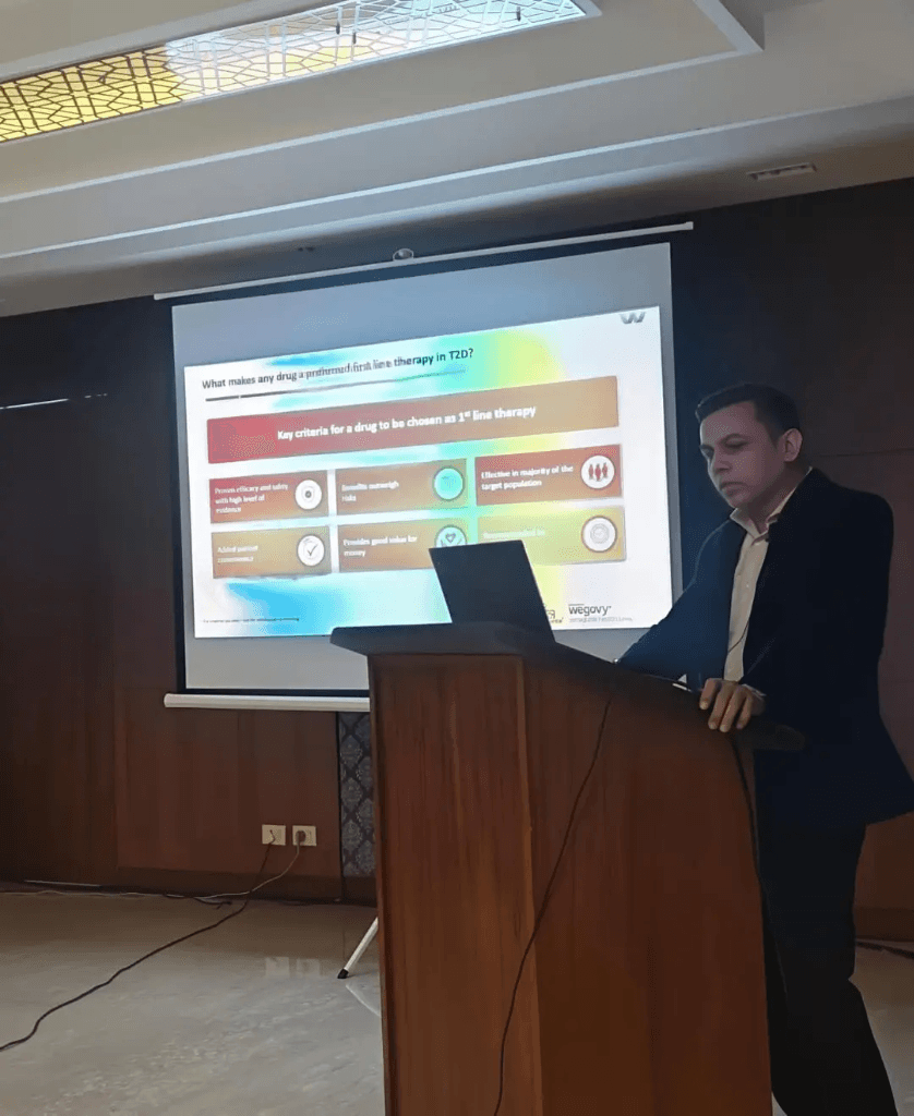 A presenter delivering a Clinical Research and CME session at a podium